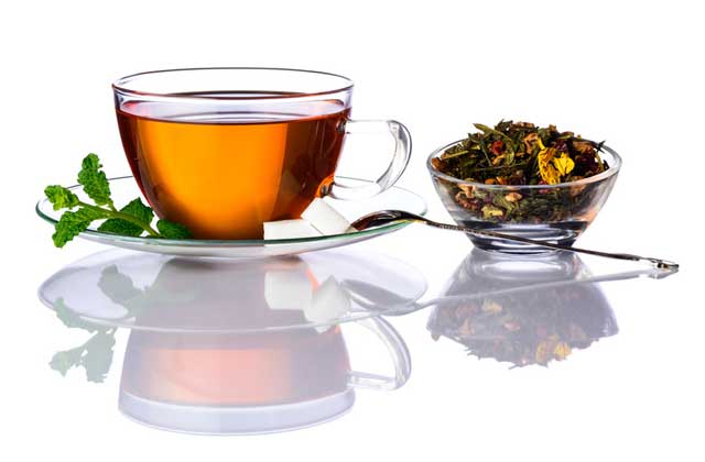 hot tea in glass mug and tea leaves